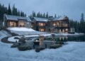 Mountain home with a fire pit terrace beside a pond in the snow